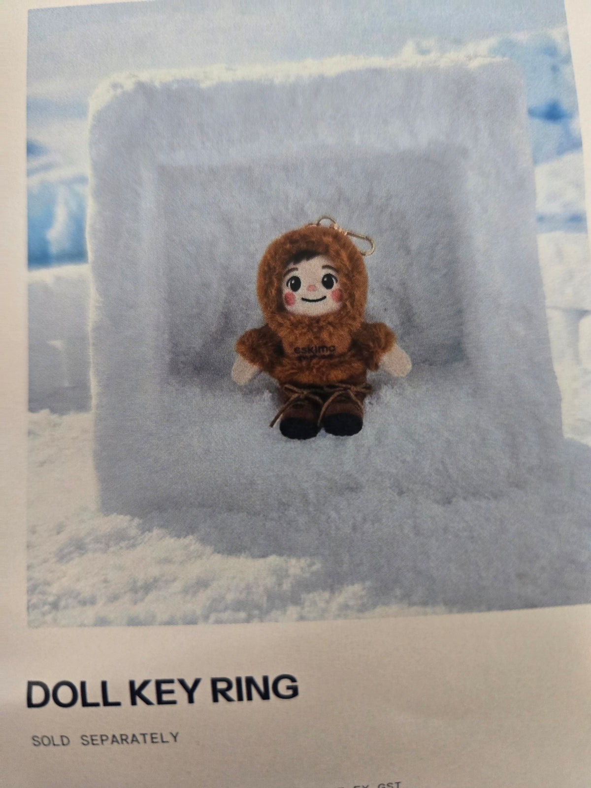 Eskimo Qubes plush Doll Key Ring with a loop attachment, displayed against an icy backdrop