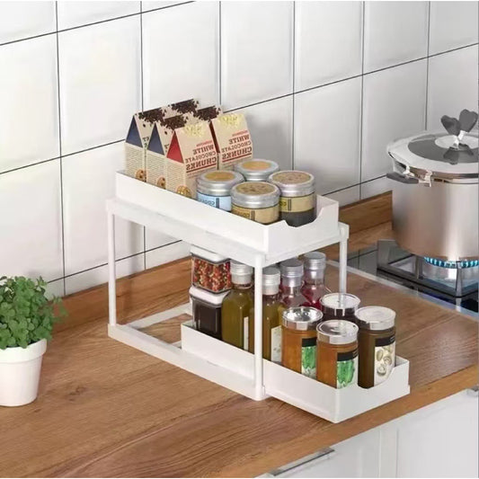 Two-tier pull-out storage rack. An organizational lifesaver for under the kitchen sink. Features adjustable shelves for easy storage of bottles and...