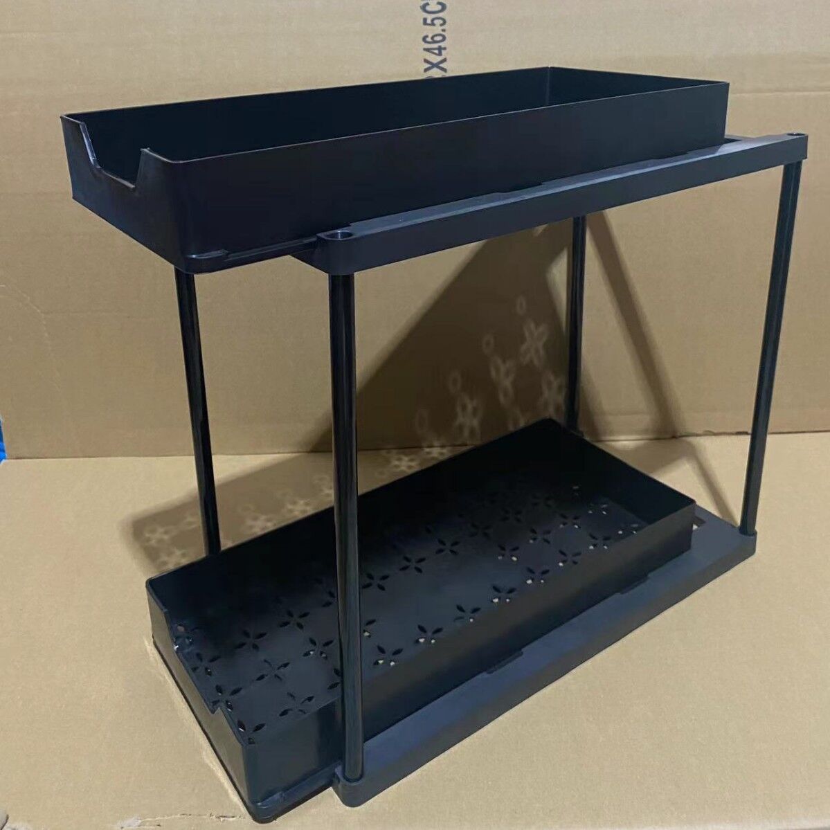 Two-tier pull-out storage rack. An organizational lifesaver for under the kitchen sink. Features adjustable shelves for easy storage of bottles and...