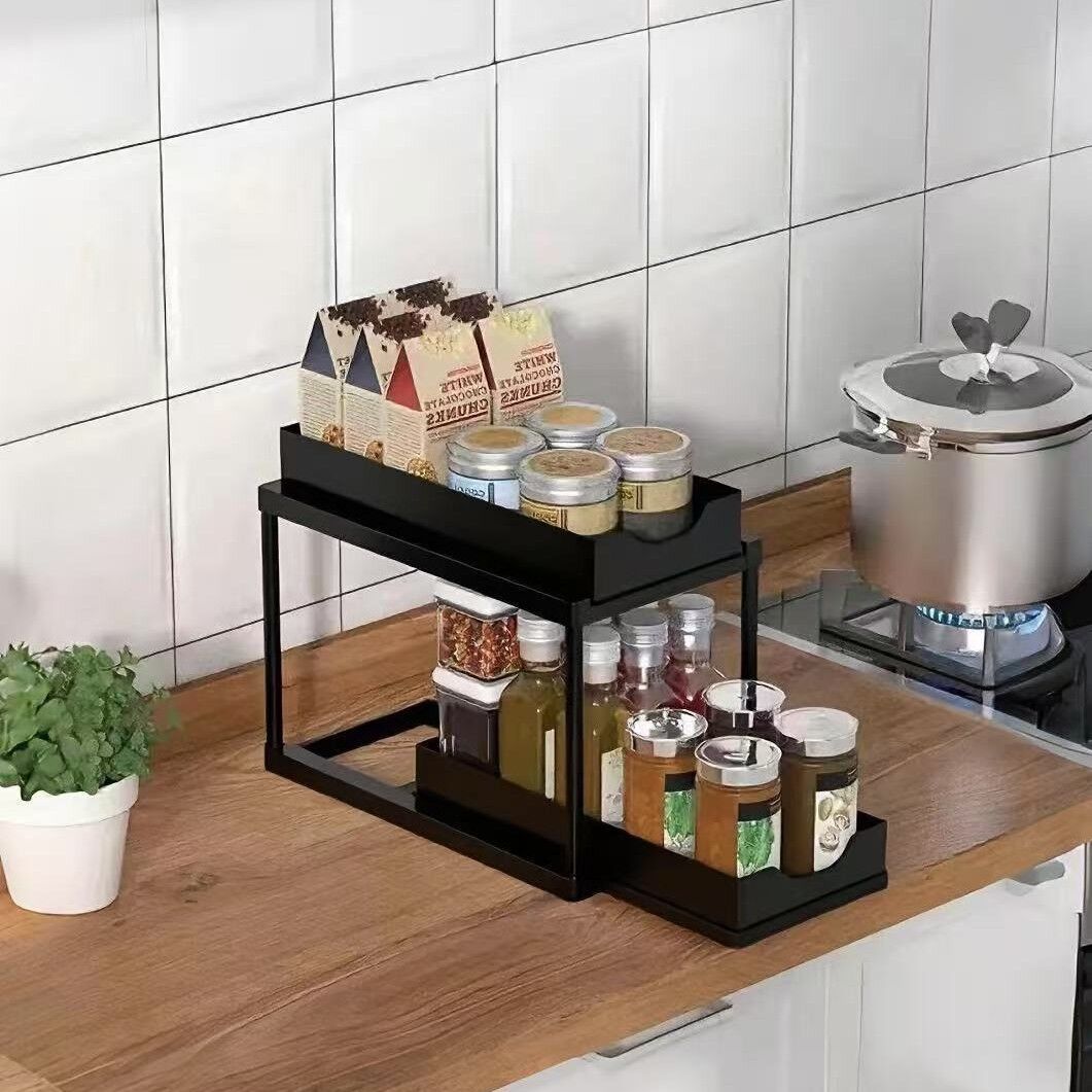 Two-tier pull-out storage rack. An organizational lifesaver for under the kitchen sink. Features adjustable shelves for easy storage of bottles and...