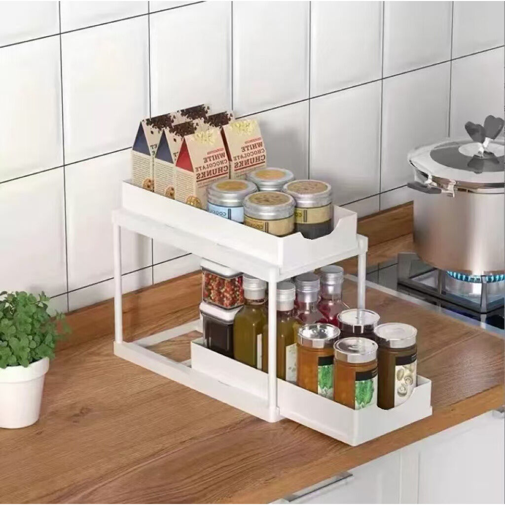 Two-tier pull-out storage rack. An organizational lifesaver for under the kitchen sink. Features adjustable shelves for easy storage of bottles and...